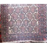 Antique Persian rug decorated with multi coloured paisley type geometric motifs upon a cream ground,