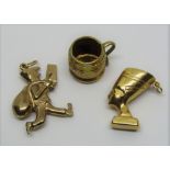 Three 9ct novelty charms comprising Nefertiti, a postman and a tankard, 6.1g total (3)