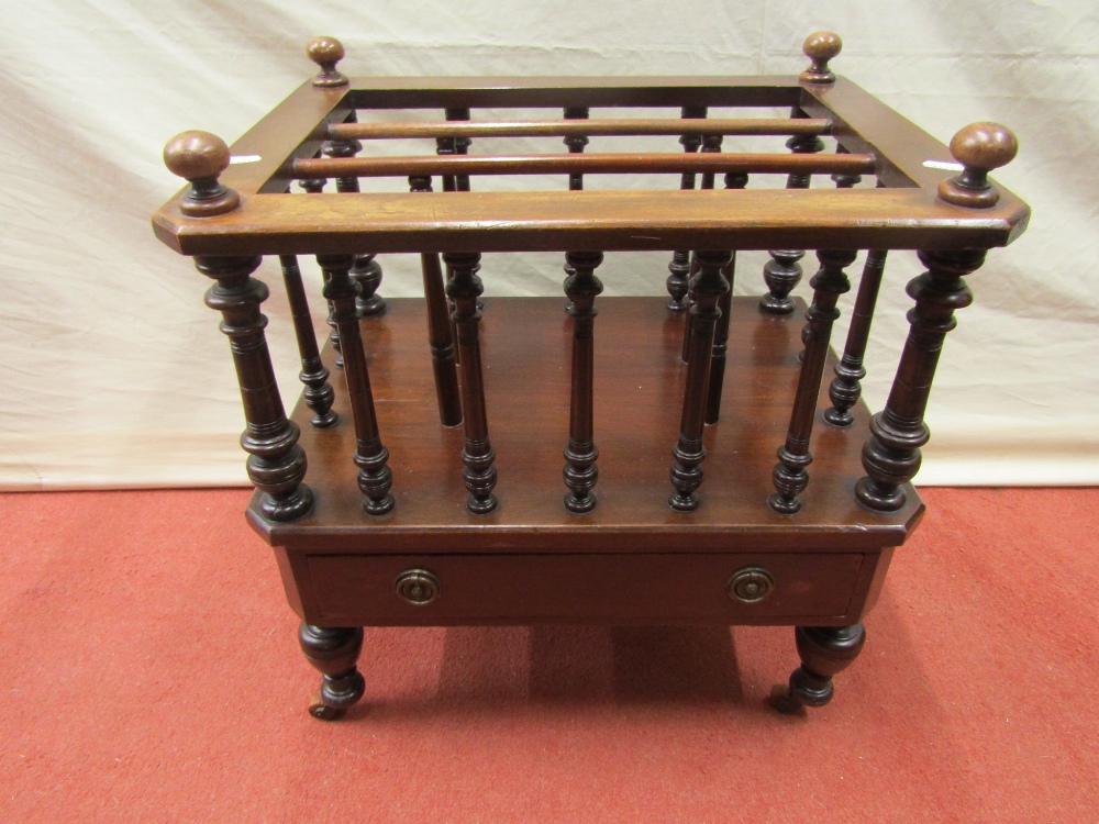 An Edwardian Canterbury with three divisions over a frieze drawer with turned spindle mouldings