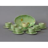 A collection of Carltonware Buttercup pattern teawares with moulded floral handles comprising oval