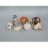 A collection of seven Royal Crown Derby Imari pattern paperweights in the form of a Badger,