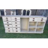 A substantial pine framed counter/kitchen island floorstanding and fitted with an arrangement of