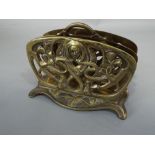 A good quality art nouveau cast brass two divisional letter rack with pierced sinuous floral and