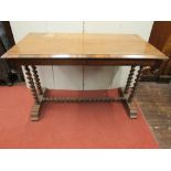 A Victorian walnut centre table, raised on four barley twist supports, united by a central rail,