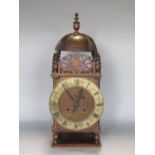 19th century twin train lantern clock with silvered chapter ring engraved with Roman numerals in a