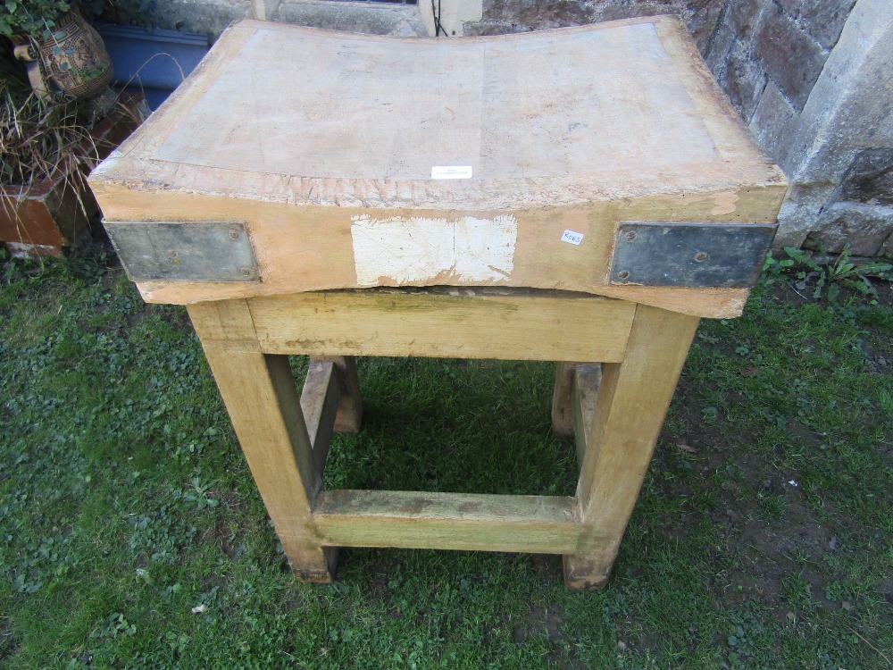 A vintage small beechwood butchers block and stand of square cut form united by stretchers, the