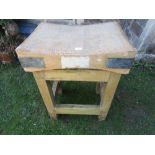 A vintage small beechwood butchers block and stand of square cut form united by stretchers, the