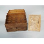 An Arts and Crafts/Cotswold style oak stationery box with hinged shaped lid, enclosing a segmented