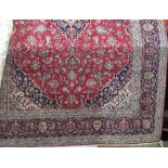 Persian Hammadan style carpet with central navy blue medallion with further scrolled foliage with