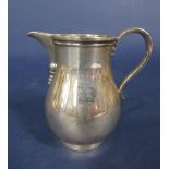 Early 20th century Georgian style cast silver baluster cream jug, engraved with the crest of a