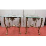 A pair of vintage occasional tables with gilded metallic frames the plate glass tops of waisted form
