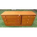 A Stag teak low long bedroom chest fitted with an arrangement of six drawers, approx 140 cm long x