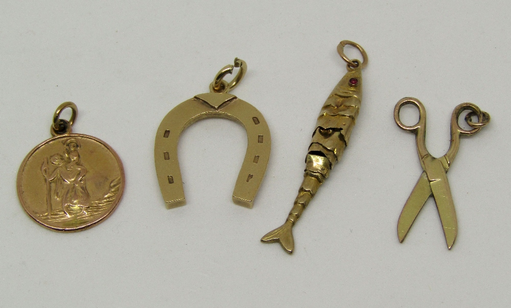 Three 9ct charms comprising horseshoe, St Christopher and an articulated fish (fish af), 6.6g total,