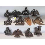 A collection of various wooden pediments and carvings of eagles and others; together with a bag