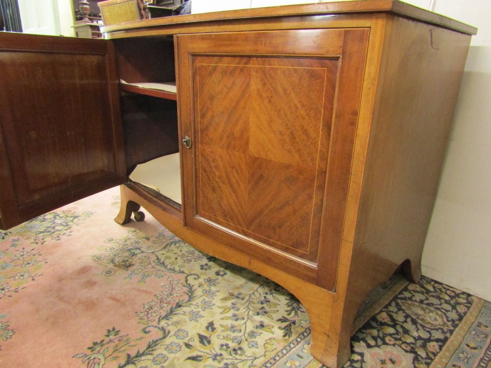 An Edwardian mahogany bow fronted side cupboard enclosed by two panelled doors, on swept supports, - Image 2 of 2