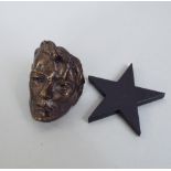 Interesting miniature cast bronze David Bowie death mask, 5cm high, upon an acrylic black star