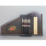 Cased ebonised auto harp, with overlaid flower decoration