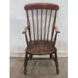 A Windsor stained elm and beechwood stick back armchair with saddle shaped seat on turned supports