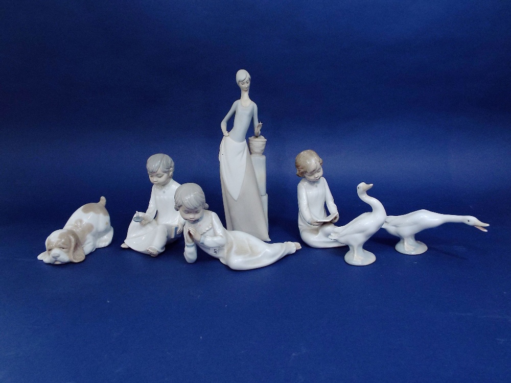 Two Lladro figures of geese, three Nao figures of children in their night clothes, a Nao puppy and a
