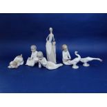 Two Lladro figures of geese, three Nao figures of children in their night clothes, a Nao puppy and a
