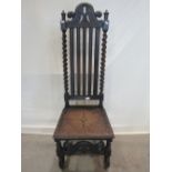 A Victorian carved oak single chair in the Carolean style, the high back with vertical moulded slats