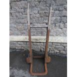 An old vintage sack truck with wooden jointed shafts and hard rubber wheels, together with two old