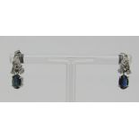 Pair of topaz and diamond drop earrings in unmarked white metal, 2.8g total