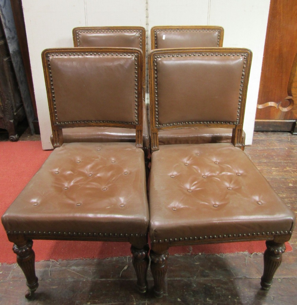 A set of four Victorian oak dining chairs by lamb of Manchester, with turned and fluted forelegs and