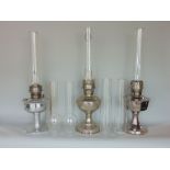 Three chrome Aladdin oil lamps model 21c square font, model 21c round font and model 11 anchor and