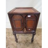 A home built vintage record cabinet enclosed by a pair of lozenge shaped and split moulded