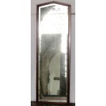 A Gothic style wall mirror of rectangular form with shallow pointed arched top, bevelled edge