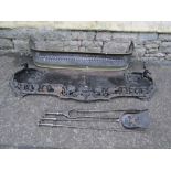 A Victorian cast iron fender with scrolling pierced fruiting vine rail with central lions mask,