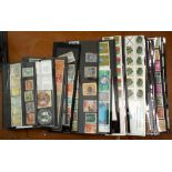A box containing a wide selection of worldwide stamps on cards (1)
