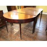 A Georgian mahogany D-end extending dining table with two additional leaves, raised on square