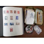 Three albums containing a quantity of worldwide stamps, together with two tin boxes containing
