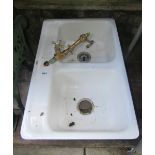 A Kohler cast iron and enamelled two divisional sink, complete with brass mixer tap, 82cm long x