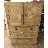 A Russell Workshops Ltd arts and crafts oak cupboard the lower section enclosed by three frieze
