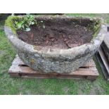 A large natural stone D shaped trough, thick walled (af) approx 138cm wide x 74cm deep x 50cm high