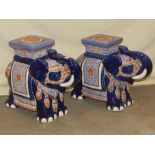 A pair of blue glazed ceramic garden seats in the form of standing elephants wearing decorative