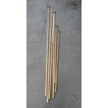 Two long snooker cues/extensions together with four cue rests of varying size, (6)
