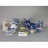 A collection of 19th century and later jugs including a Coalport Caughley reproduction example,