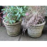 A pair of weathered contemporary cast composition stone planters of circular tapered form with