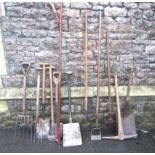 A collection of mainly vintage long handled gardening related tools including a number of ashwood