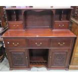 An unusual late Victorian/Edwardian sideboard, the lower section partially enclosed by a pair of