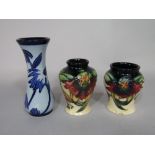 Two Moorcroft vases with lily decoration on a cream and blue ground, both dated 98 and with