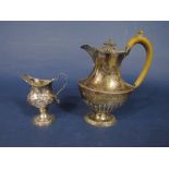 Late 19th century silver baluster water pot, with half fluted decoration in gadrooned foot rim,