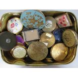 A box containing a collection of vintage compacts