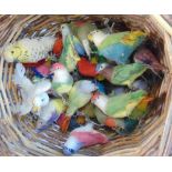 A wicker basket containing a collection of felt and wool work birds