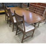 A contemporary Ercol elm drawleaf dining table of rectangular form with moulded outline and