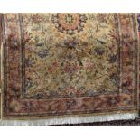 Keshan type full pile carpet with central blue floral medallion framed by further scrolled foliage